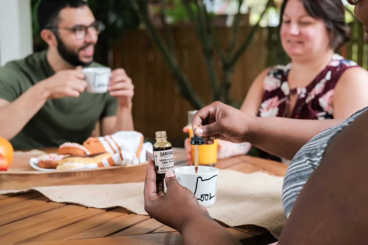 A group of friends enjoys Danodan while hanging out.