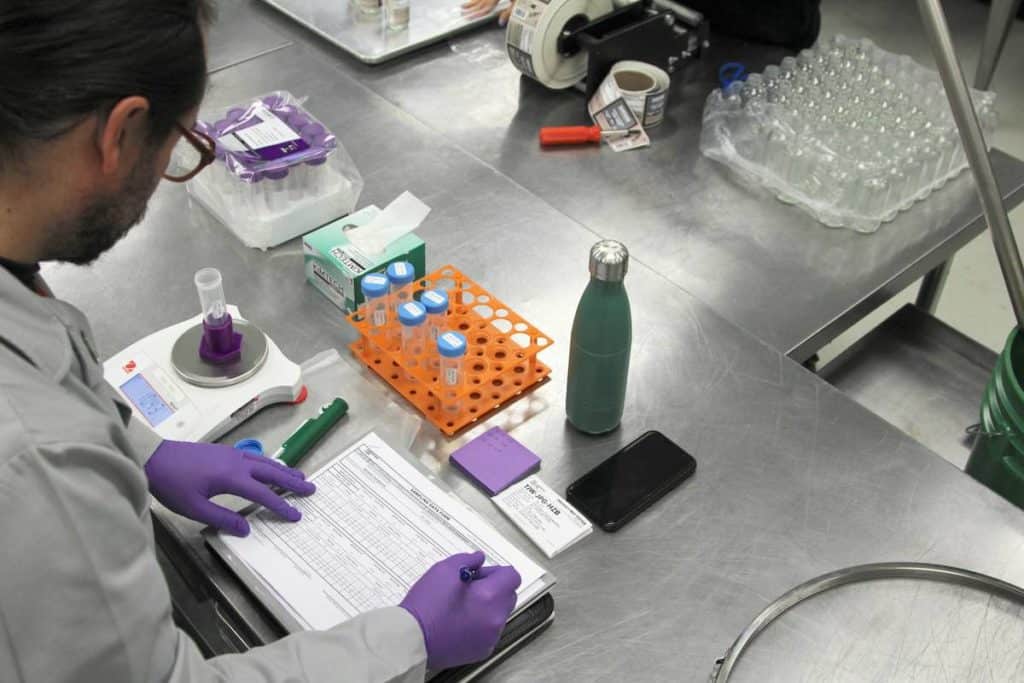 Lab technician fills out paperwork for his test sample.