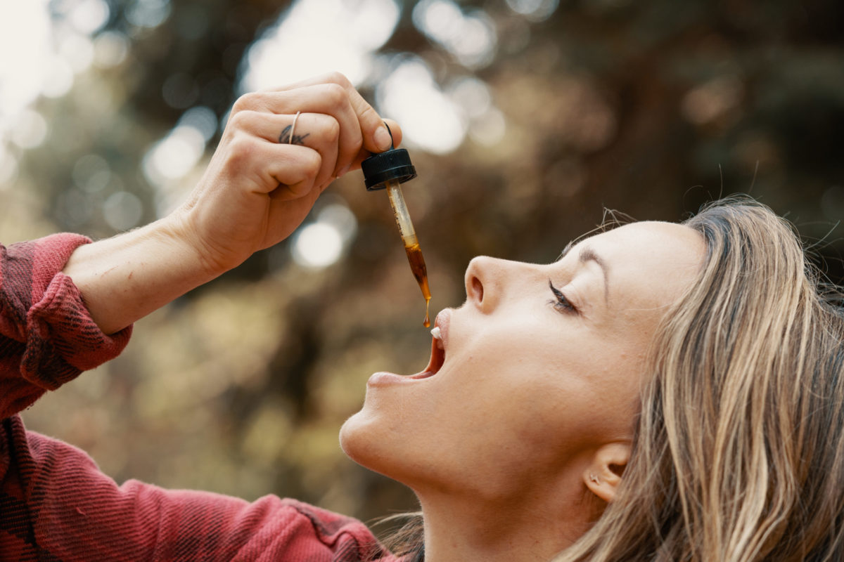 Woman uses Danodan CBD for oral health
