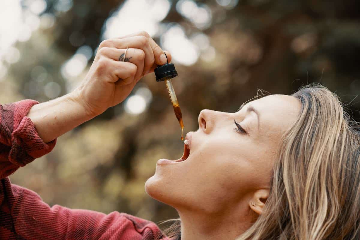 Woman uses Danodan CBD for oral health