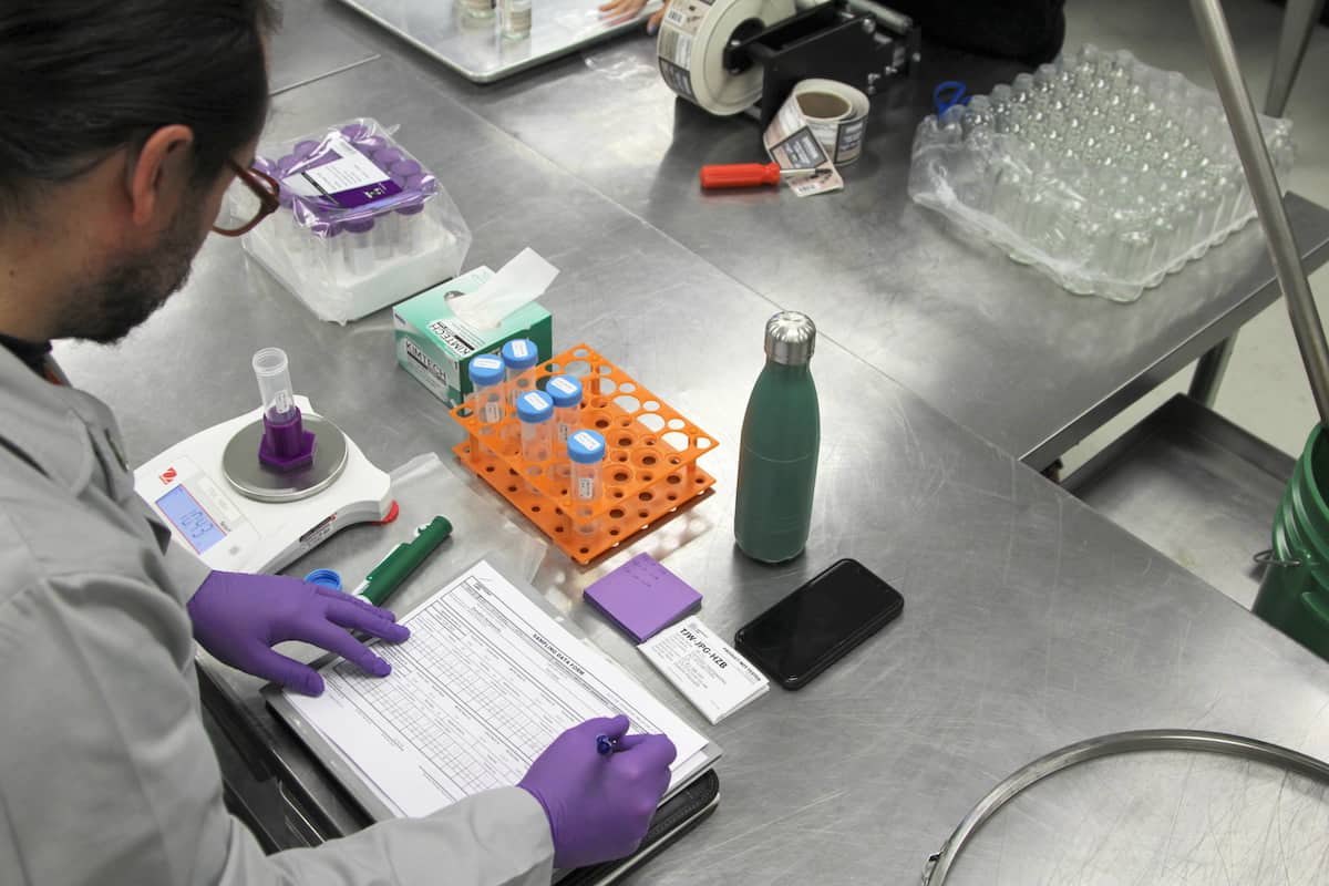 A lab technician collects samples at our facility, for Danodan quality standards for potency.